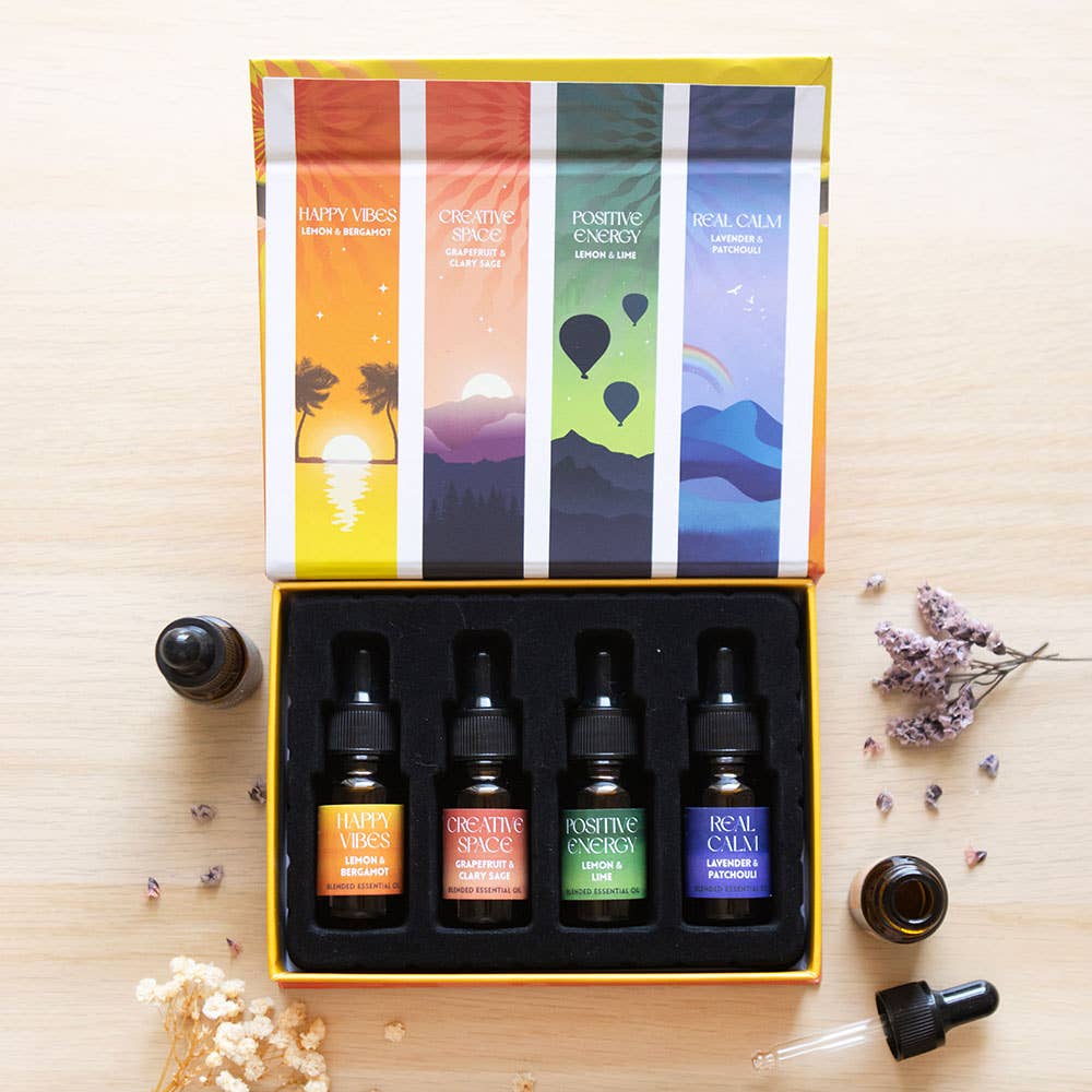 Lifestyle image of a gift set containing 4 essential oils from the happy colection.