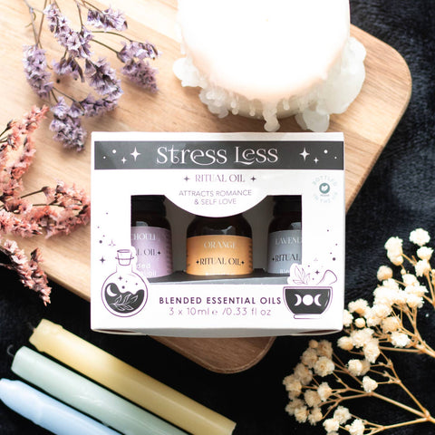 Lifestyle image of a set of 3 blended essential oils, presented in a lovely gift box, scents are orange, lavender and Patchouli. 